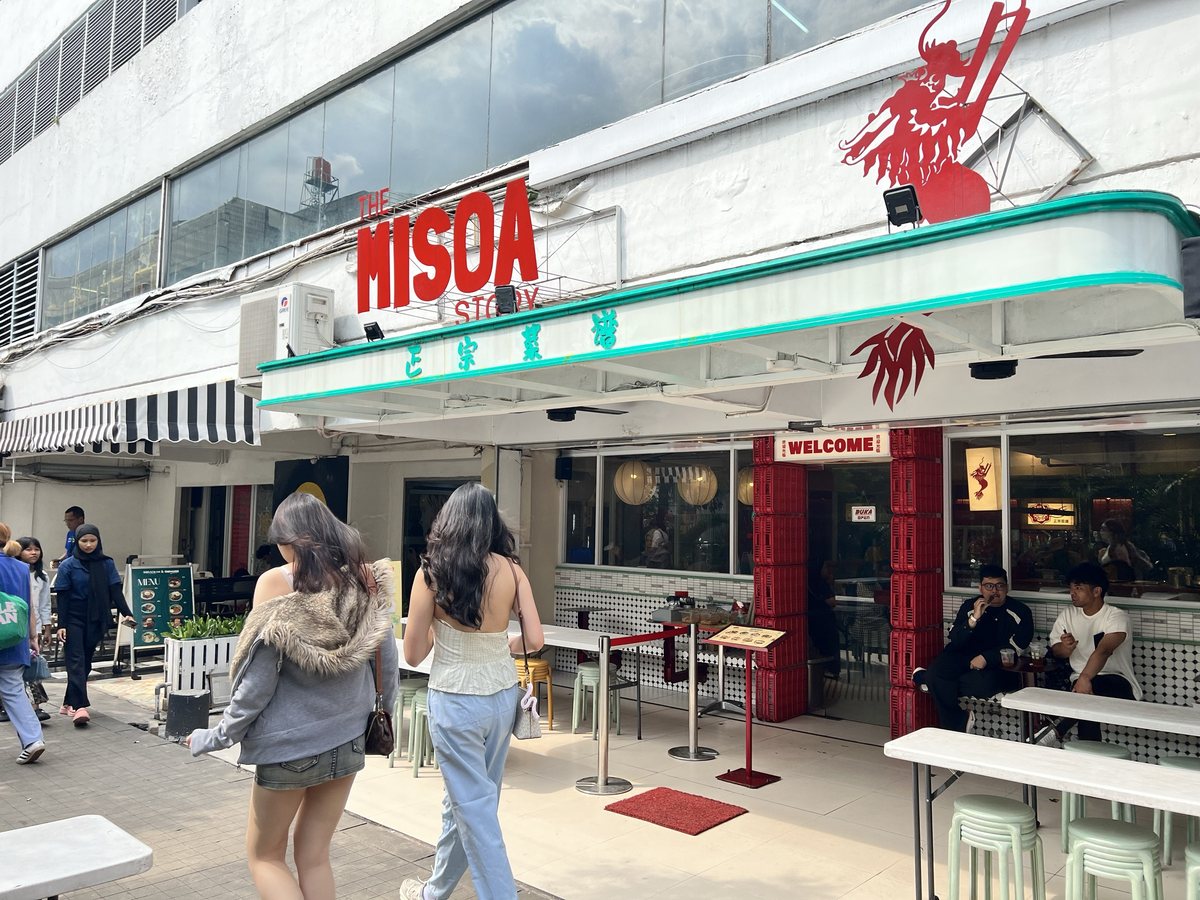 The same Pasaraya retail street after the revamp - tenants trading and shoppers walking through